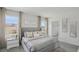 Bright bedroom with a soft grey bed, bedside tables, and plenty of natural light from multiple windows at 33072 Osprey Peak Way, San Antonio, FL 33576