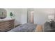 Bedroom with neutral color tones, a large dresser with decor, and a comfortable bed with throw pillows at 33072 Osprey Peak Way, San Antonio, FL 33576