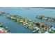 Stunning aerial view of waterfront homes with private docks and lush landscaping on a sunny day at 333 Midway Is, Clearwater Beach, FL 33767