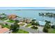 Aerial view of a waterfront home with a large backyard, dock, and boat lift at 333 Midway Is, Clearwater Beach, FL 33767