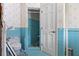 Retro bathroom with blue tiles featuring a toilet and stall shower at 333 Midway Is, Clearwater Beach, FL 33767