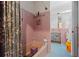 Retro bathroom featuring a tub with shower, tiled walls, and a vintage charm at 333 Midway Is, Clearwater Beach, FL 33767