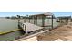 Private boat dock with a covered lift, set against a serene waterfront backdrop at 333 Midway Is, Clearwater Beach, FL 33767