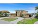 Exterior elevation of a two-story home with a circular driveway and well-maintained landscaping at 333 Midway Is, Clearwater Beach, FL 33767