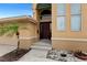 Home's front entrance features a custom wood door and tropical landscaping at 333 Midway Is, Clearwater Beach, FL 33767