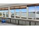 Living room featuring large windows showcasing stunning water views and natural light at 333 Midway Is, Clearwater Beach, FL 33767