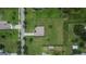 Drone eye view of a home with a long driveway, large green lawn, and mature landscaping at 3411 Knoxville Pl, Plant City, FL 33566