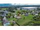 Expansive aerial view of a well-maintained home with a lush green lawn in a desirable neighborhood at 3411 Knoxville Pl, Plant City, FL 33566
