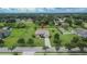 Expansive aerial view of a well-maintained home with a large yard, mature trees, and established landscaping at 3411 Knoxville Pl, Plant City, FL 33566