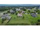 Aerial view of a single-story home with a large yard, shed, and well-kept lawn in a residential neighborhood at 3411 Knoxville Pl, Plant City, FL 33566