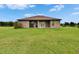 The rear exterior of this house features a covered patio and an expansive lawn at 3411 Knoxville Pl, Plant City, FL 33566