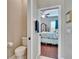 View from bathroom to bedroom with four-poster bed and wood floors at 3411 Knoxville Pl, Plant City, FL 33566