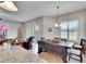 The dining area offers ample sunlight, wood floors, and a table set for an intimate gathering at 3411 Knoxville Pl, Plant City, FL 33566