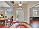 Inviting foyer features a decorative rug, front door with sidelight, and natural light from windows with shutters at 3411 Knoxville Pl, Plant City, FL 33566