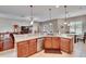 Open concept kitchen features a breakfast bar, stainless steel appliances, and ample counter space at 3411 Knoxville Pl, Plant City, FL 33566