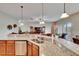 Open kitchen overlooking the living area, featuring granite countertops and a breakfast bar at 3411 Knoxville Pl, Plant City, FL 33566