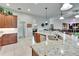 Bright kitchen with granite countertops, stainless steel sink, and access to the dining and living areas at 3411 Knoxville Pl, Plant City, FL 33566