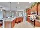 Spacious kitchen boasts stainless steel appliances, granite countertops, and warm wood cabinetry at 3411 Knoxville Pl, Plant City, FL 33566