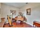 Bright living room featuring hardwood floors, a harp, a baby grand piano, and natural light at 3411 Knoxville Pl, Plant City, FL 33566