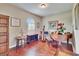 Elegant living room showcases hardwood floors, a baby grand piano, and ample natural light through arched windows at 3411 Knoxville Pl, Plant City, FL 33566