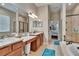 Bathroom boasting double sink, granite countertops, walk-in shower, and soaking tub at 3411 Knoxville Pl, Plant City, FL 33566