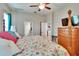 Bedroom with ceiling fan, four poster bed, adjacent bathroom and doorway at 3411 Knoxville Pl, Plant City, FL 33566