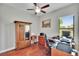 Office featuring a ceiling fan, wooden floors, desk, and storage at 3411 Knoxville Pl, Plant City, FL 33566