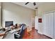 Bright office space featuring a hardwood floor, ceiling fan, and spacious desk area for a productive work environment at 3411 Knoxville Pl, Plant City, FL 33566