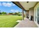 Covered outdoor patio featuring gas grill and view of the large backyard at 3411 Knoxville Pl, Plant City, FL 33566