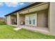 Covered outdoor patio featuring gas grill and view of the large backyard at 3411 Knoxville Pl, Plant City, FL 33566