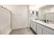 Bright bathroom features a double vanity with white cabinets and a tiled floor at 3528 Maple Grove Way, Plant City, FL 33565