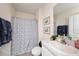 Clean bathroom featuring a shower with blue curtain, single vanity, and tile floor at 3528 Maple Grove Way, Plant City, FL 33565