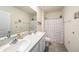 Modern bathroom features a double vanity, granite countertop, and shower with floral curtain at 3528 Maple Grove Way, Plant City, FL 33565
