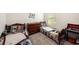 Shared bedroom with two beds, wooden dresser, and carpeted floor at 3528 Maple Grove Way, Plant City, FL 33565