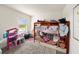 Bright ' bedroom with a bunk bed, dollhouse, and view of the water at 3528 Maple Grove Way, Plant City, FL 33565