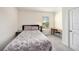Cozy bedroom with a patterned quilt, desk, and view of the outdoors at 3528 Maple Grove Way, Plant City, FL 33565