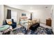 Charming bedroom featuring a wooden bed frame, blue accent chair, and colorful rug at 3528 Maple Grove Way, Plant City, FL 33565