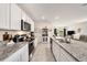 Modern kitchen featuring white cabinets, granite countertops, and stainless steel appliances at 3528 Maple Grove Way, Plant City, FL 33565