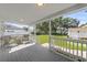 Covered back porch with comfortable seating overlooks well-manicured yard at 4002 W Watrous Ave, Tampa, FL 33629