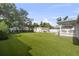 Backyard with artificial turf and a backyard cottage at 4002 W Watrous Ave, Tampa, FL 33629