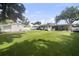 Large grassy backyard features a cottage and covered entertainment area at 4002 W Watrous Ave, Tampa, FL 33629