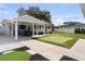 Spacious backyard with a putting green and covered patio for outdoor dining and entertaining at 4002 W Watrous Ave, Tampa, FL 33629