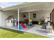 Covered patio features play area and ample seating, with an outdoor astroturf lawn at 4002 W Watrous Ave, Tampa, FL 33629
