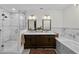 Modern bathroom with double vanity, marble counters, soaking tub, and glass shower at 4002 W Watrous Ave, Tampa, FL 33629