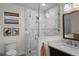Updated bathroom featuring glass shower doors, marble, updated fixtures, and modern design at 4002 W Watrous Ave, Tampa, FL 33629