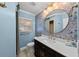Stylish bathroom featuring blue accents, a round mirror, and a modern vanity at 4002 W Watrous Ave, Tampa, FL 33629