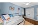 bedroom features wood floors, bright blue walls, and ample natural light at 4002 W Watrous Ave, Tampa, FL 33629