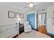 Cozy Bedroom featuring wood floors, bright blue trim, and crisp white walls at 4002 W Watrous Ave, Tampa, FL 33629