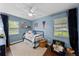Bright blue bedroom featuring wood floors, light and neutral accents, and ample natural light at 4002 W Watrous Ave, Tampa, FL 33629