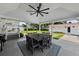 The backyard has a covered patio with a ceiling fan, outdoor kitchen, and patio dining set at 4002 W Watrous Ave, Tampa, FL 33629